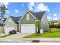 Charming home featuring a two-car garage, well-manicured lawn, and inviting curb appeal at 518 Judge Ct, Durham, NC 27703