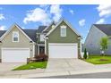 Charming home featuring a two-car garage, well-manicured lawn, and inviting curb appeal at 518 Judge Ct, Durham, NC 27703