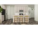 Stylish kitchen with white countertops and wood stools at the central island at 525 Morning Light Dr # 33, Angier, NC 27501