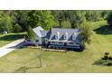 Expansive aerial view of a two-story home with a large lawn and surrounding trees at 530 Turlington Rd, Dunn, NC 28334