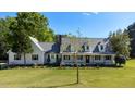 Beautifully landscaped front yard of a classic two-story home on a sunny day at 530 Turlington Rd, Dunn, NC 28334