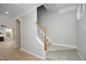 Carpeted staircase with white banisters and wood handrail, leading to the upper level of the home at 6022 Four Townes Lane Ln, Raleigh, NC 27616