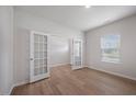 Bright office featuring hardwood floors, fresh paint, natural light from the window, and glass French doors at 708 Deschutes Dr, Garner, NC 27529
