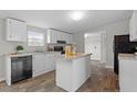 Bright kitchen featuring an island, lots of storage, and modern appliances at 7289 Nc 561, Louisburg, NC 27549