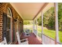 Relaxing front porch view with rocking chairs, perfect for enjoying the outdoors at 7371 Leasburg Rd, Roxboro, NC 27574