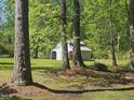 Rear view of a storage barn with a green lawn at 952 Glover Rd, Dunn, NC 28334