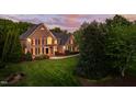 Beautiful two-story brick home showcasing lush landscaping and a well-maintained green lawn at 10 Twinleaf Pl, Durham, NC 27705