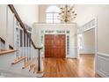 Grand foyer features hardwood floors, double doors, staircase, chandelier, and an abundance of natural light at 10 Twinleaf Pl, Durham, NC 27705