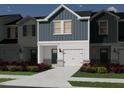 Rendering of new townhome showing modern designs, attached garages, and colorful landscaping at 1048 Winding Spring Dr, Mebane, NC 27302