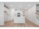 Modern kitchen featuring white cabinets, stone countertops, and stainless steel appliances at 1048 Winding Spring Dr, Mebane, NC 27302