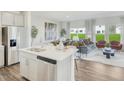 Open concept living space features an island, stainless steel appliances, and lots of natural light at 1048 Winding Spring Dr, Mebane, NC 27302