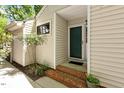 Inviting home entryway featuring a green front door and brick steps at 108 Woodglen Dr, Cary, NC 27518
