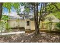 Home exterior featuring brick detail and mature trees at 108 Woodglen Dr, Cary, NC 27518