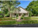 Inviting home with a classic design, a sprawling lawn, and mature trees at 109 N Hassel St, Hillsborough, NC 27278