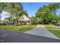 Classic home with a bluestone driveway, mature trees, and a well-manicured lawn at 109 N Hassel St, Hillsborough, NC 27278