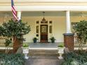 Welcoming front porch with decorative columns, pendant lighting, and a cozy atmosphere at 109 N Hassel St, Hillsborough, NC 27278