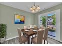 Elegant dining room features a wooden table, seating for six, and sliding glass doors to the backyard at 121 Drumbuie Pl, Garner, NC 27529