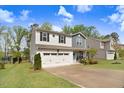 Inviting two-story home with a two-car garage, well-kept lawn, and charming curb appeal at 130 Stromness Path, Clayton, NC 27527
