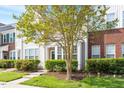 Inviting townhome with lush landscaping and a quaint front porch at 135 Cedar Elm Rd, Durham, NC 27713