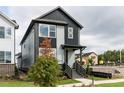 Modern two-story home with black and gray siding, landscaped yard, and inviting front entrance at 14 Relaxing Way, Pittsboro, NC 27312