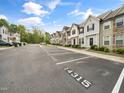 Exterior street view of the townhome community with assigned, numbered parking spaces and mature trees at 14315 Foxcroft Rd, Raleigh, NC 27614