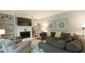 Comfortable living room with a fireplace, built-in bookshelves, and a large sectional sofa at 1505 Sharnbrook Ct, Raleigh, NC 27614
