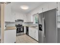 Bright kitchen with stainless steel appliances, white cabinetry, and granite countertops at 154 Luther Rd, Raleigh, NC 27610