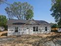 New home under construction with wrapped facade and visible framing, set on a cleared lot at 156 Southern Middle School Rd, Roxboro, NC 27573