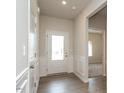 Bright entryway featuring a white front door and wood-look floors, offering a welcoming ambiance at 182 E Victory View Ter, Smithfield, NC 27577