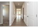 Inviting hallway with wood-look flooring and wainscoting, leading to various rooms in the house at 182 E Victory View Ter, Smithfield, NC 27577