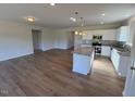Open floor plan showing island kitchen with granite countertops and stainless appliances at 182 E Victory View Ter, Smithfield, NC 27577
