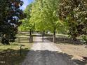 View of the property's gated entrance, driveway, and manicured surroundings at 220 Jordan Narron Rd, Selma, NC 27576