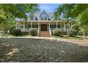 Charming home exterior featuring a welcoming front porch with ample seating and beautiful landscaping at 220 Jordan Narron Rd, Selma, NC 27576