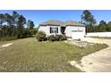 Single-story home showcasing a well-maintained lawn, complemented by vibrant landscaping and a classic design at 226 Kandypoo Dr, Four Oaks, NC 27524