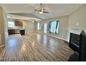 Inviting living room featuring vaulted ceilings, wood-look floors, a fireplace, and bright natural light at 226 Kandypoo Dr, Four Oaks, NC 27524