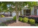 Beautiful exterior view showcasing the townhome's stone facade, well-manicured landscaping, and inviting entryway at 2307 Carriage Oaks Dr, Raleigh, NC 27614
