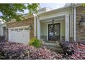 Inviting front entrance with stone accents, double doors, and decorative wreaths at 2307 Carriage Oaks Dr, Raleigh, NC 27614