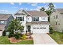 Two-story home featuring a two-car garage, manicured landscaping, and a welcoming front porch at 2912 Historic Cir, Morrisville, NC 27560