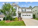 Charming two-story home featuring a two-car garage, manicured landscaping, and a welcoming front porch at 2912 Historic Cir, Morrisville, NC 27560
