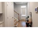 Bright foyer with hardwood floors, coat closet, and staircase to upper level at 3005 Dunnock Dr, Durham, NC 27713