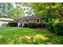 Cozy brick home with lush landscaping and a neatly maintained lawn at 315 Clark St, Durham, NC 27701