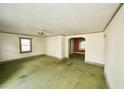 Bright living room featuring a ceiling fan, multiple windows, and a view to other rooms at 315 Clark St, Durham, NC 27701