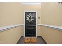Charming front door with decorative wreath and welcome mat, inviting guests into the home at 324 Providence Glen Dr, Chapel Hill, NC 27514