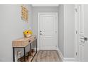 Inviting hallway featuring wood flooring, console table, and neutral paint at 324 Providence Glen Dr, Chapel Hill, NC 27514