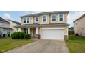 Well-maintained two-story home featuring an attached garage, concrete driveway, and manicured front lawn at 3513 Diamond Springs Dr, Raleigh, NC 27610