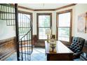 Sunlit office space featuring a spiral staircase, wood paneling, and tile flooring at 3704 Hesters Store Rd, Hurdle Mills, NC 27541