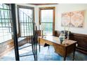 Well-lit office space featuring a spiral staircase, wood paneling, and tile flooring at 3704 Hesters Store Rd, Hurdle Mills, NC 27541