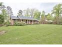 Charming brick ranch with large front yard and mature trees offering curb appeal at 4005 King Charles Rd, Durham, NC 27707
