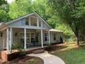 Beautiful front yard with lush trees and landscaping adding to the home's curb appeal at 4172 Copeland Ter, Graham, NC 27253