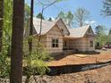 Exterior framing of new home showing covered porch and surrounding wooded area at 485 Chapel Ridge Dr, Pittsboro, NC 27312